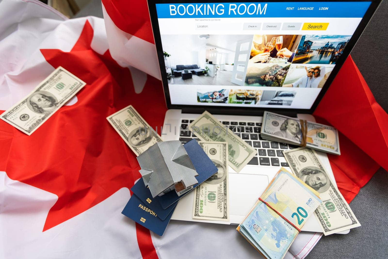 travel laptop, money and Canadian flag.