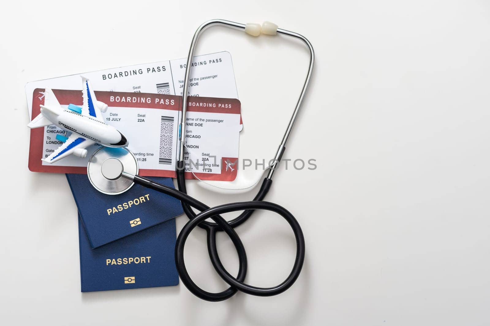 stethoscope, toy airplane on a white background. health insurance on a travel trip. by Andelov13