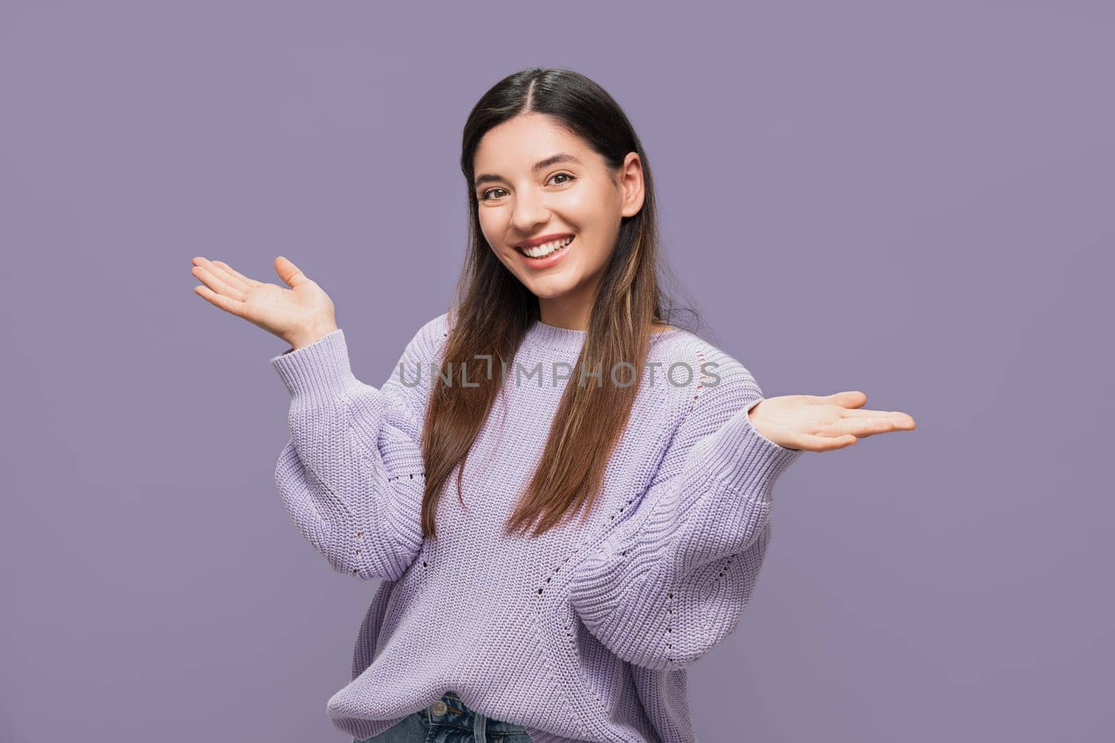 Welcoming. Beautiful smiling, attractive young woman happily gesturing with her hands this is it by AndreiDavid