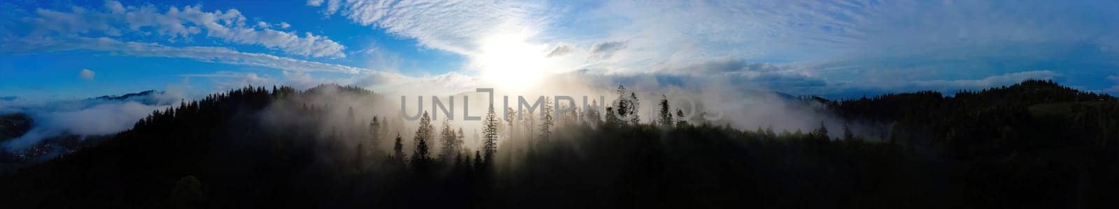 Panoramic Mountain landscape in fog, landscape with misty mountain forest, sun under peak by igor010