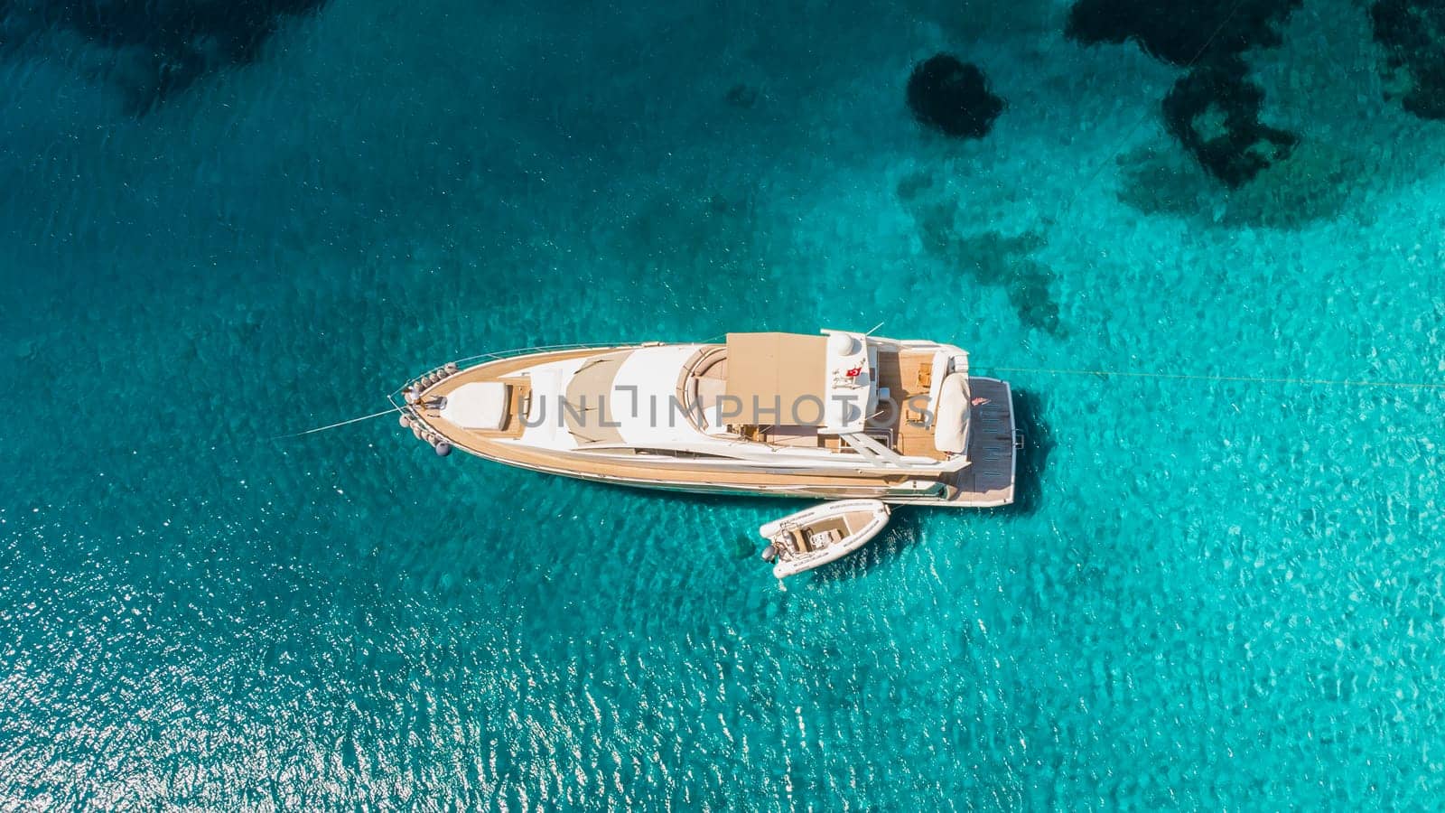 Luxury yacht on the water sea surface from top view. Turquoise water background from top view. Summer seascape from air. by igor010