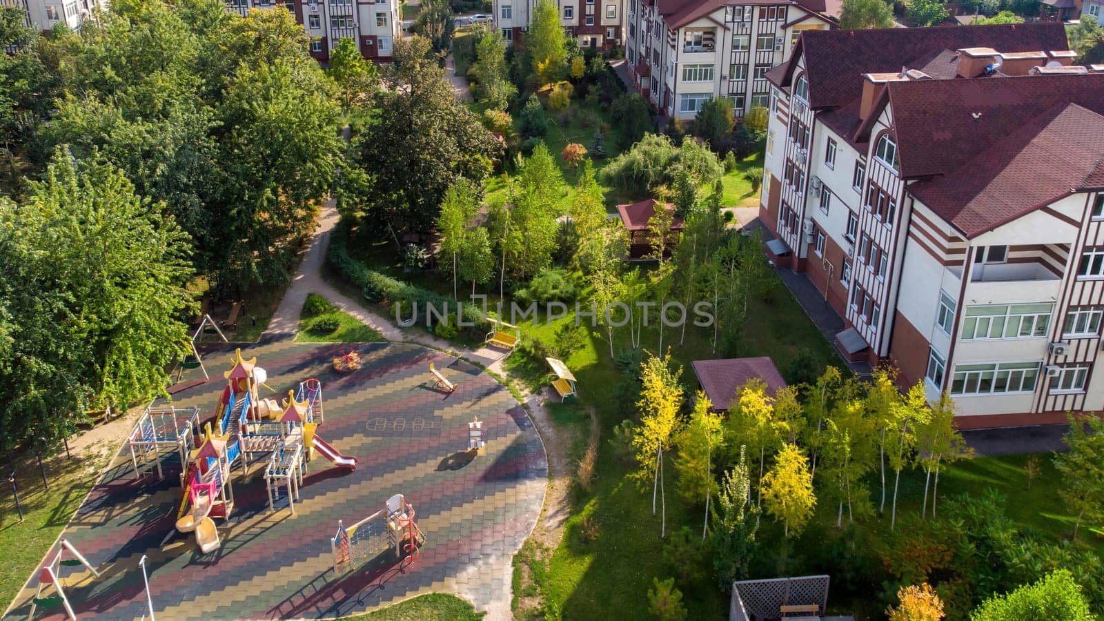 Aerial Children's playground. View of colorful playground in city park. Empty modern outdoor playground in springtime. Beautiful place for kids games and sport