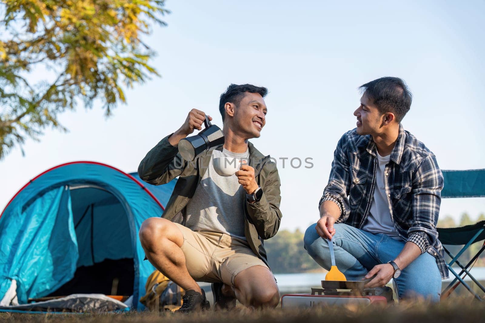 Happy Asian male gay couple on camping together in a forest. romantic vocation trip. lgbt concept by nateemee