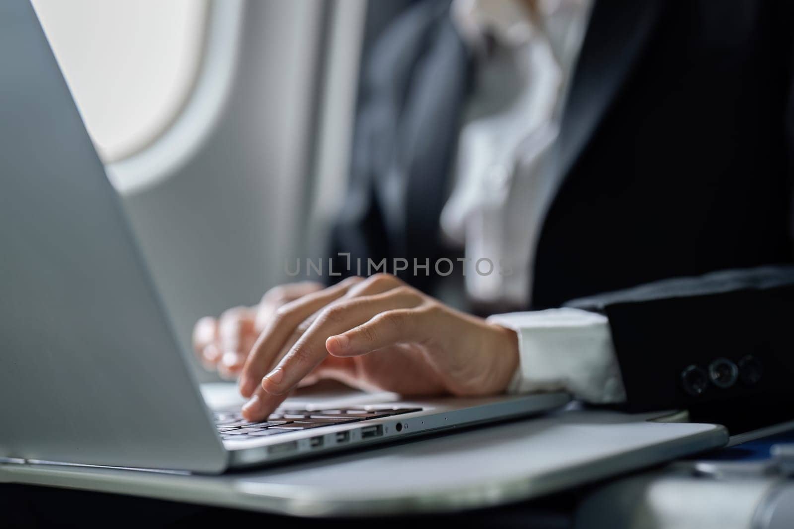 Beautiful Asian businesswoman working with laptop in aeroplane. working, travel, business concept.