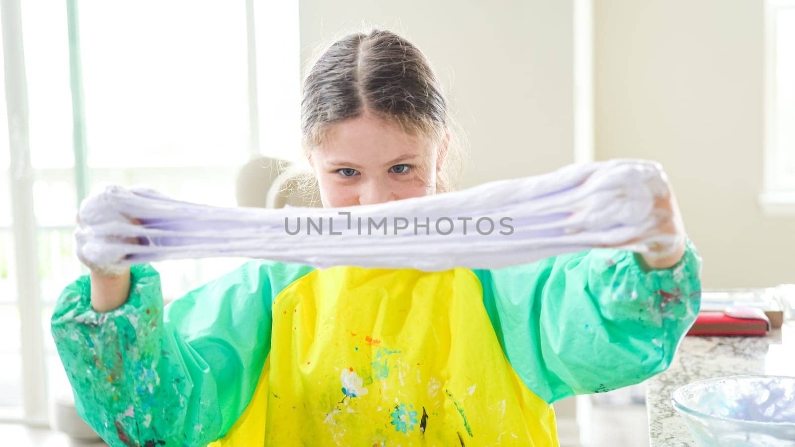Homeschooled Little Girl Crafting Slime in Modern Kitchen by arinahabich