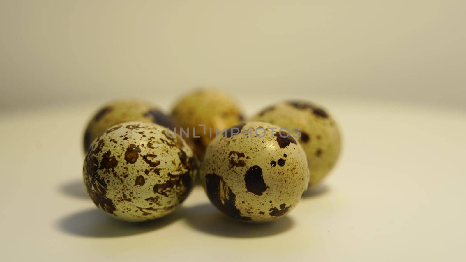 Spotted quail eggs on a light background, natural eco-friendly products