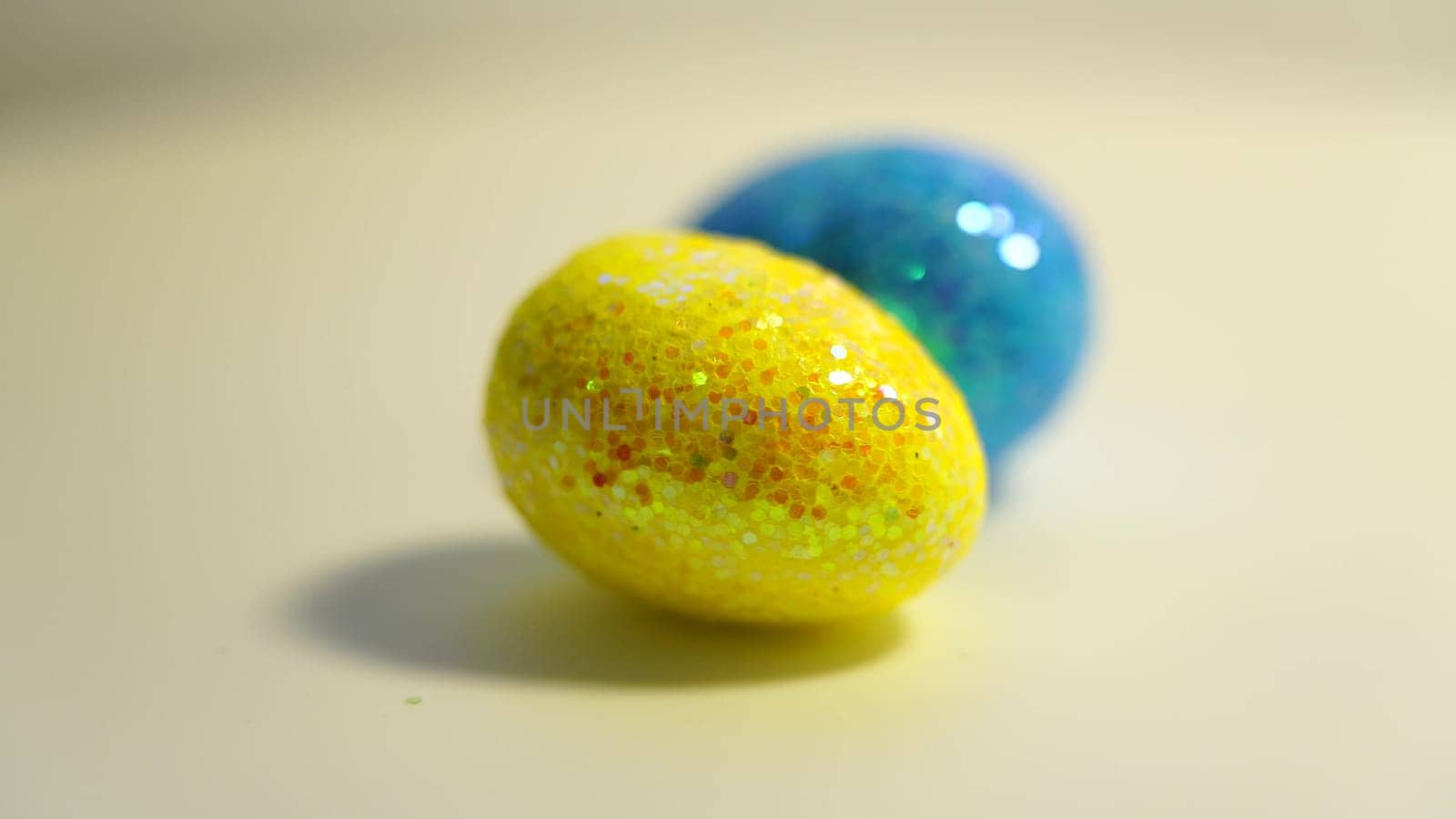 Colorful Easter eggs rotating in rows in a seamless loop on a light background.