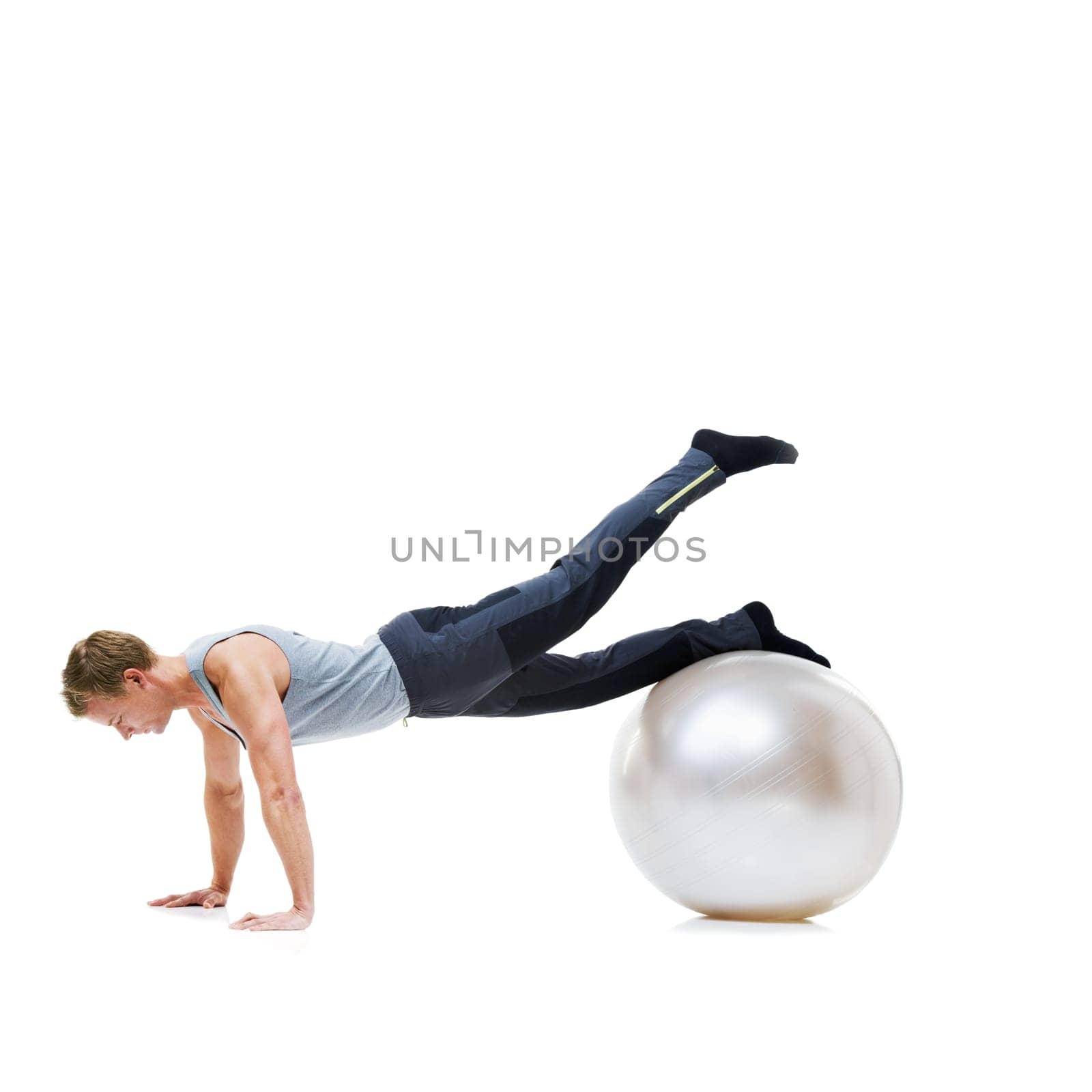 Yoga ball, fitness and man in a studio with a body, health and wellness exercise for balance. Sports, equipment and young male athlete with stretching workout or training isolated by white background by YuriArcurs