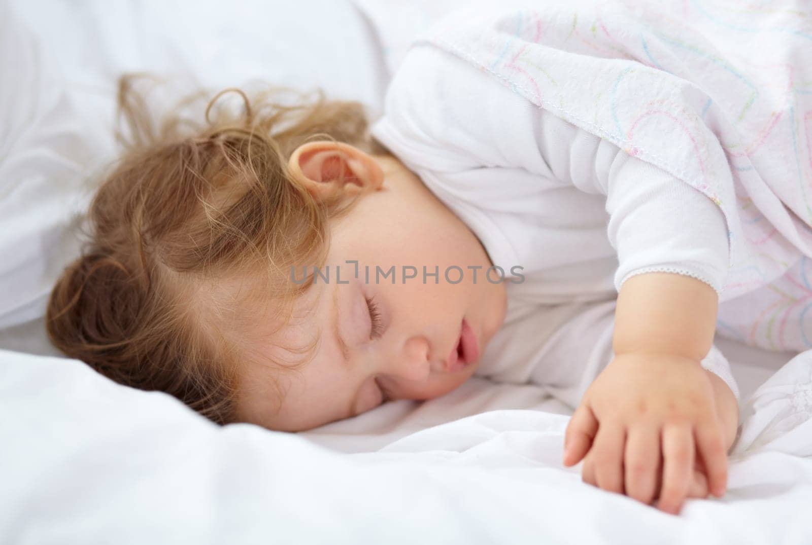Face, baby and kid sleeping on bed for calm break, peace and dreaming to relax at home. Tired young child asleep with blanket for newborn development, healthy childhood growth or rest in nursery room by YuriArcurs