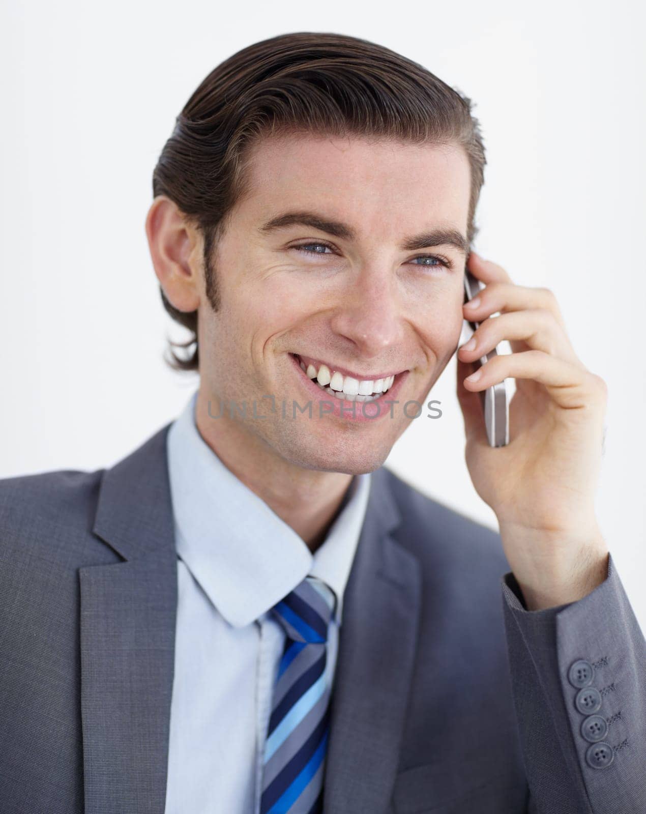 Businessman, smile and phone call for communication in studio with mockup, white background and closeup. Male consultant, talking and mobile with excited expression by cellular, network or internet by YuriArcurs
