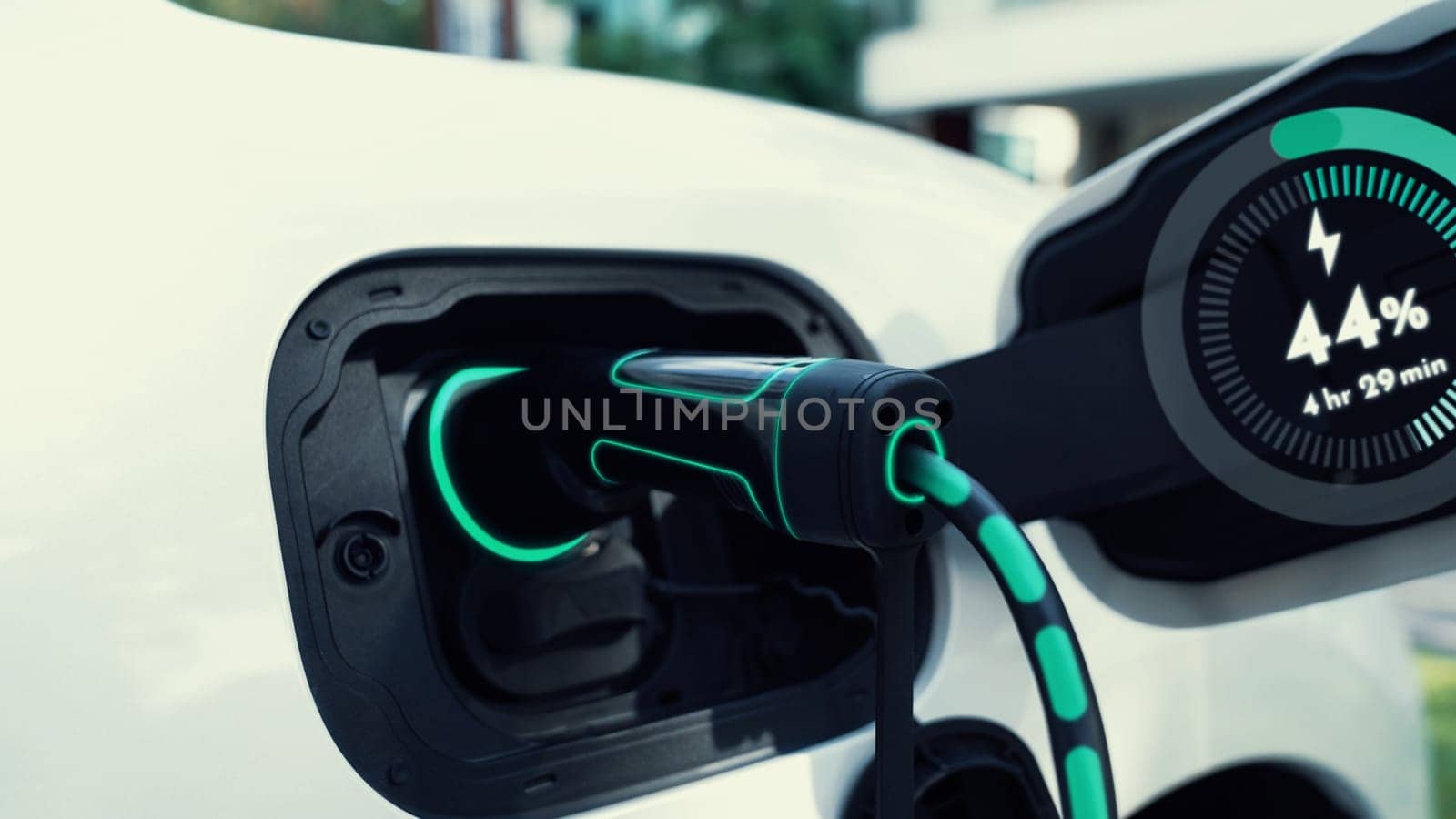 Closeup EV charger from home charging station recharging electric car. Peruse by biancoblue