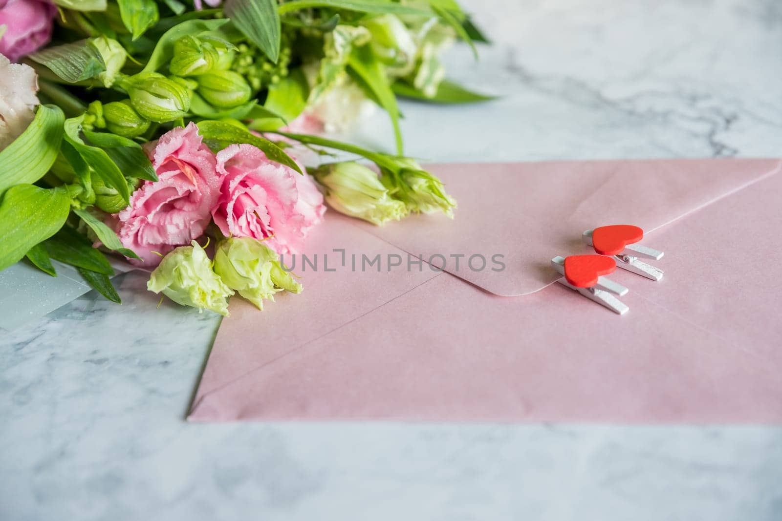 Festive flat lay arrangement of pale pink roses, envelope, hearts, .Valentine's day, mother's day, wedding, birthday Copy space Top view