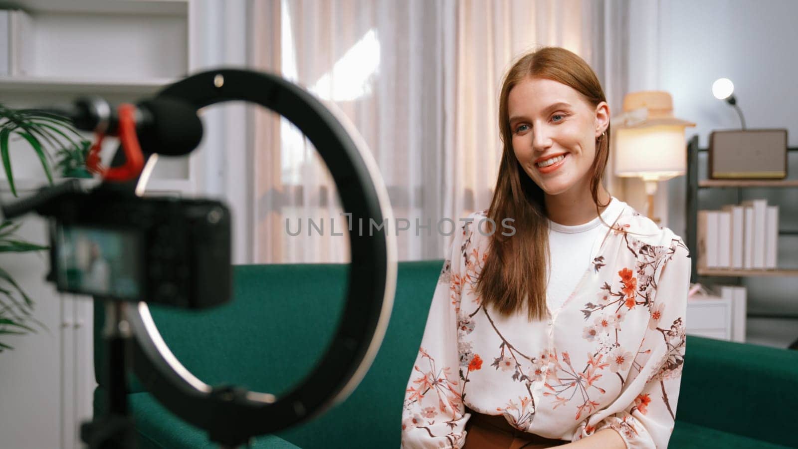 Woman influencer shoot live streaming vlog video review clothes prim social media or blog. Happy young girl with apparel studio lighting for marketing recording session broadcasting online.