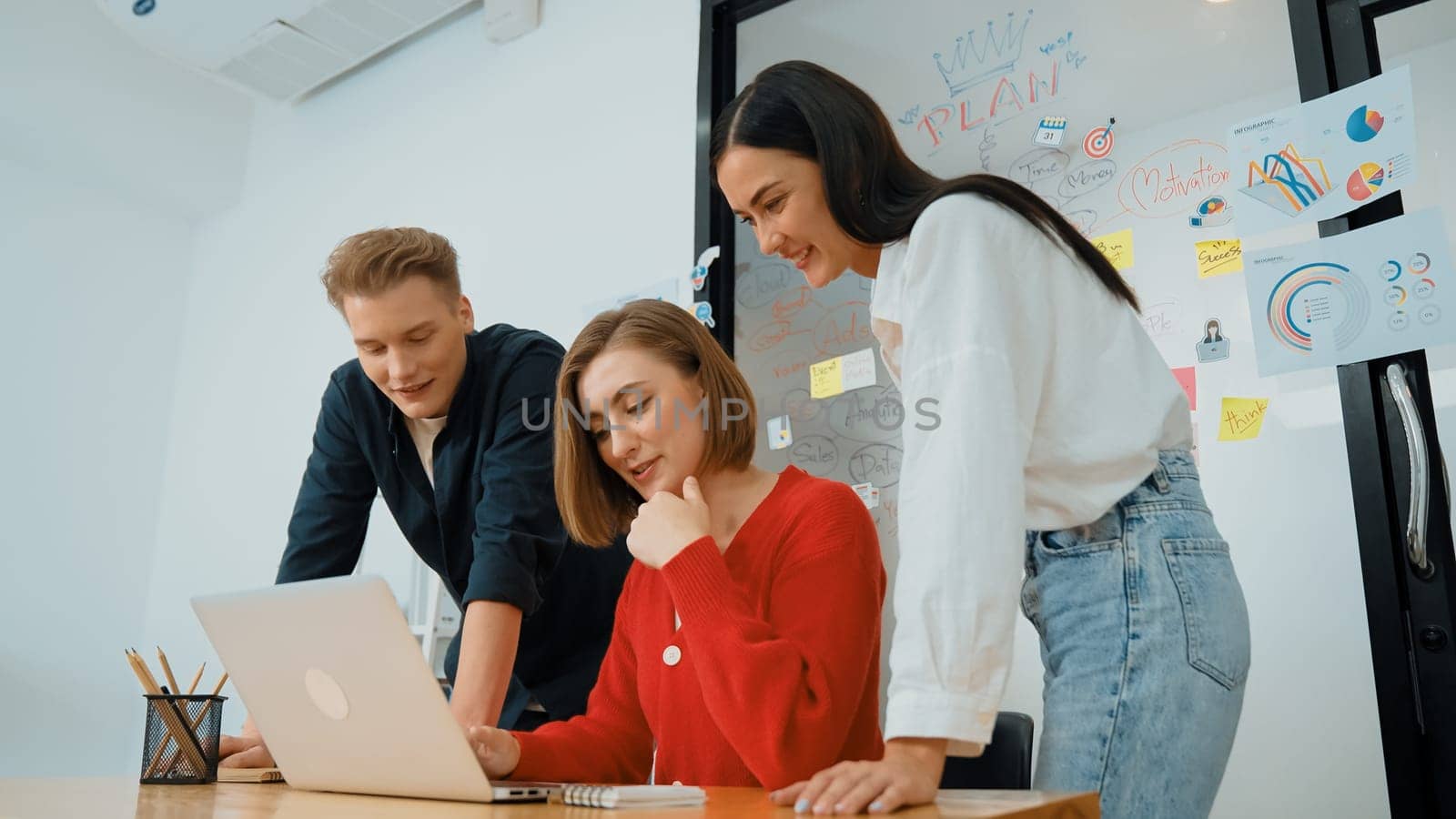 Professional business team working together in start up project at business meeting in front of glass board with mind map while colleague brainstorming and discussing about strategy. Immaculate.