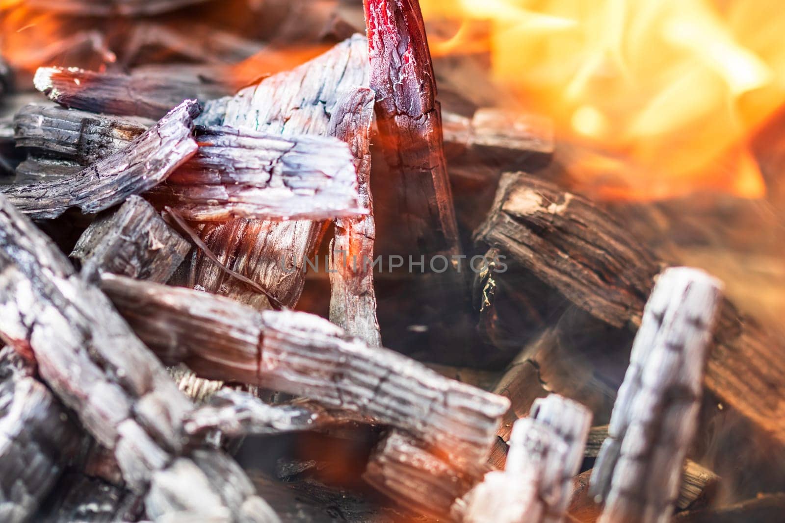 Burning wood chips forming coal. Barbecue preparation, fire before cooking. Hot coal made of greatly heated wood. by vladispas