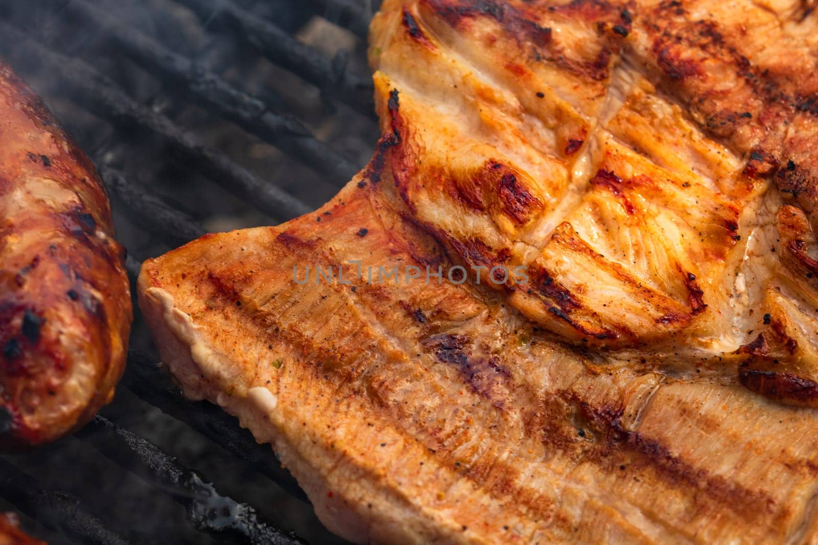 Close up on details of homemade chicken steak on barbecue grill. Barbecue, grill and food concept.
