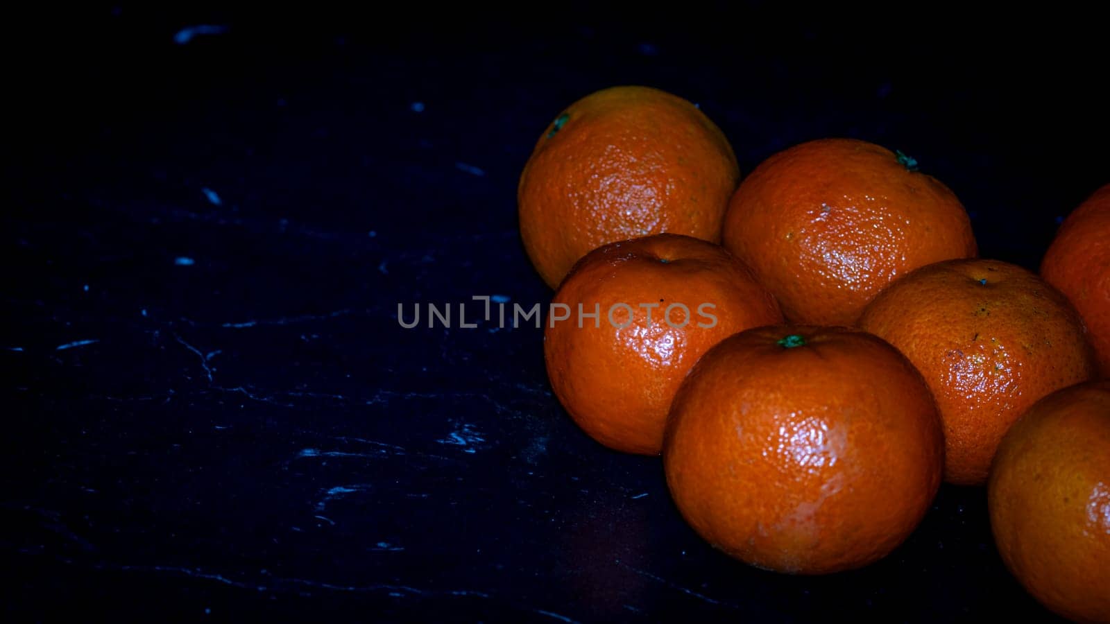 Detail of orange fruit on black background by vladispas