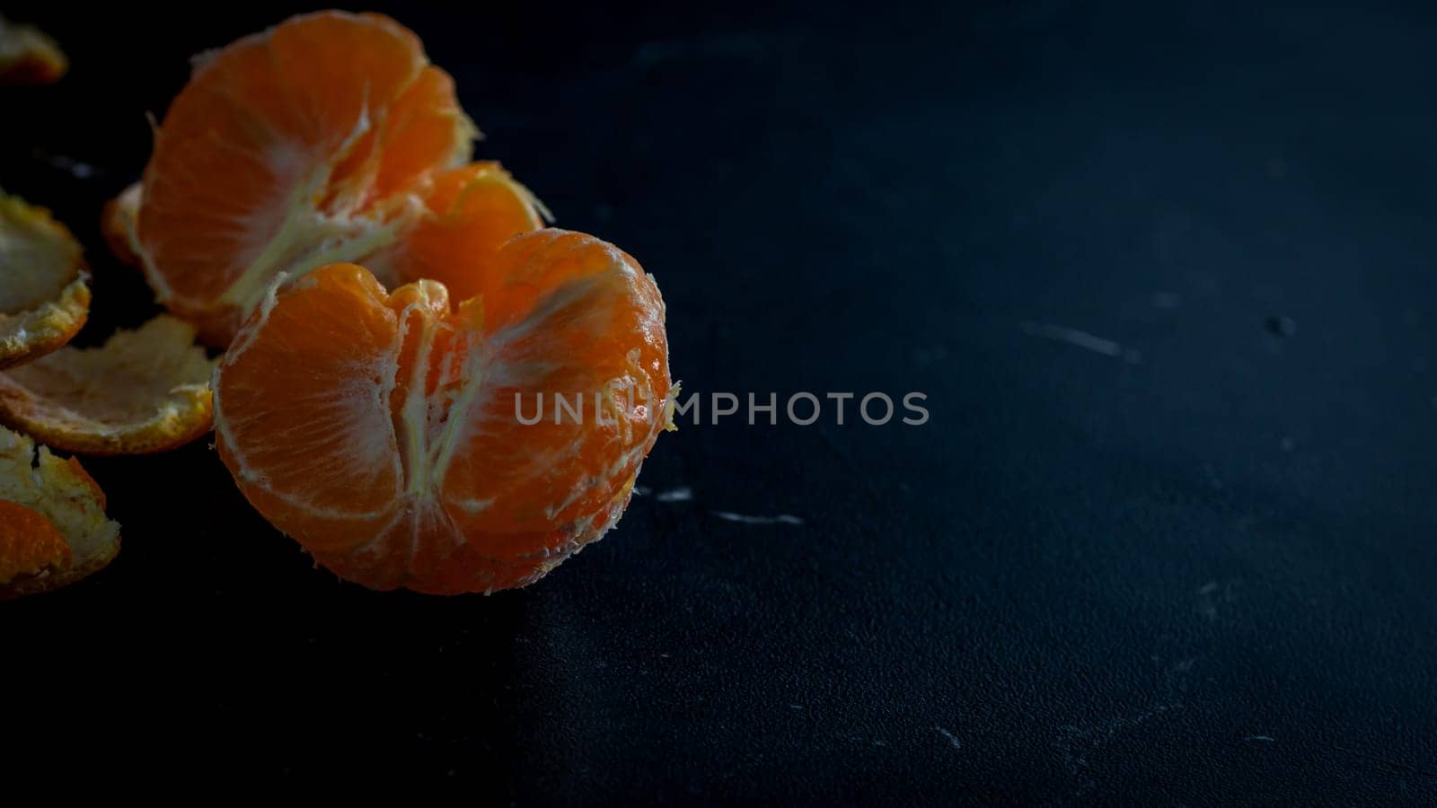 Sliced oranges on black background. Fresh fruit isolated on black