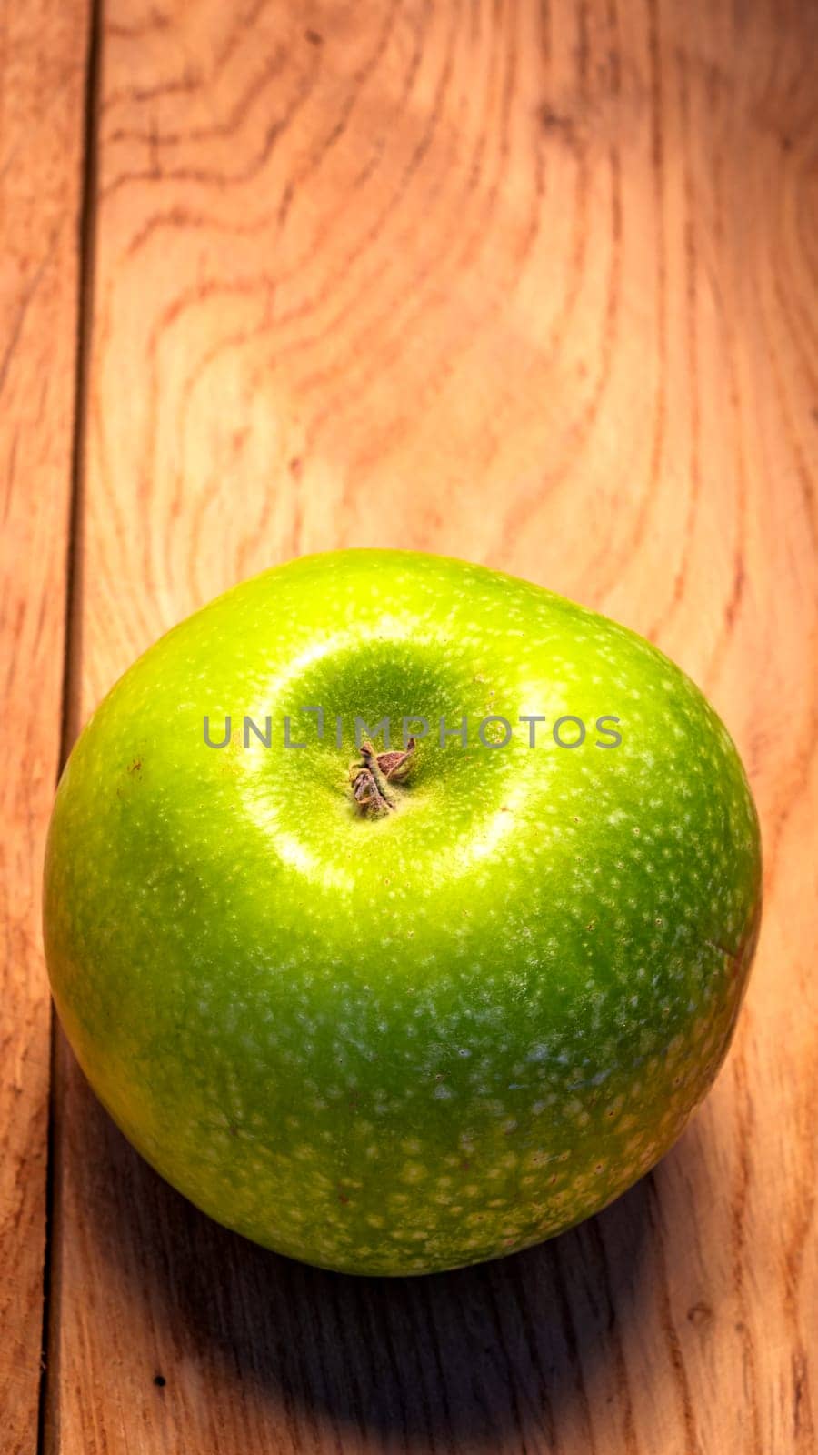 Tasty organic green juicy green apples on a rustic wooden background by vladispas