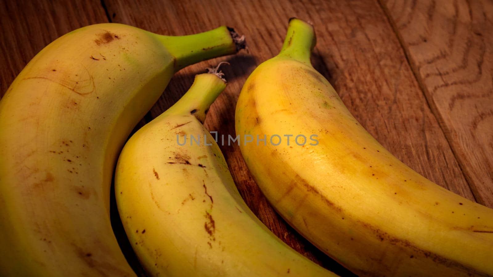 Fresh ripe bananas on a wooden board.