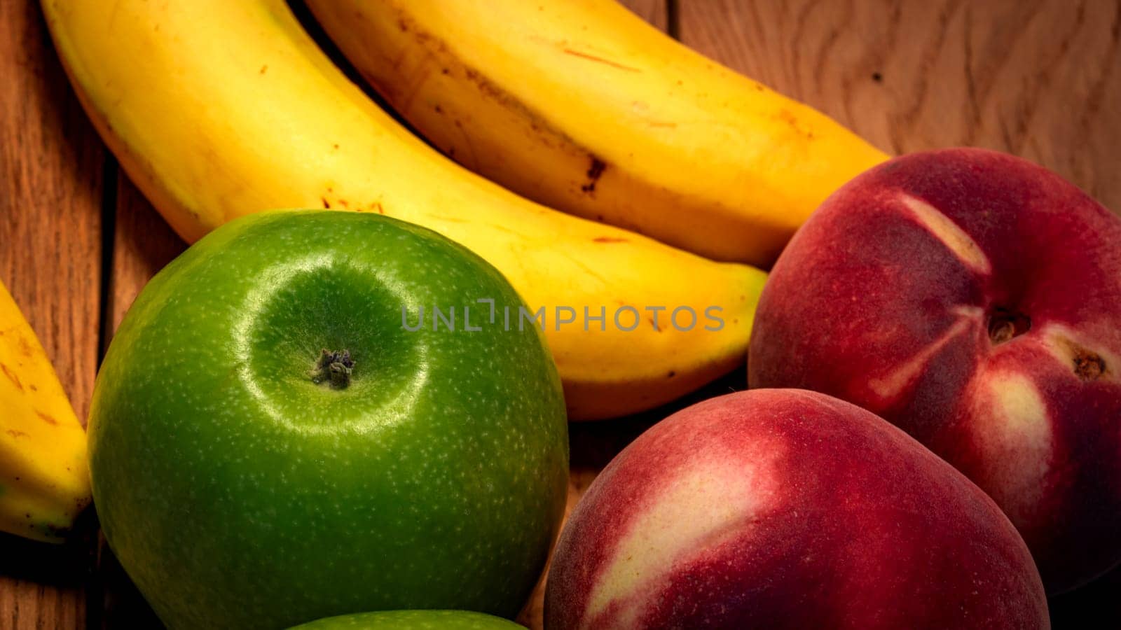 Mix of fresh fruits on wooden table