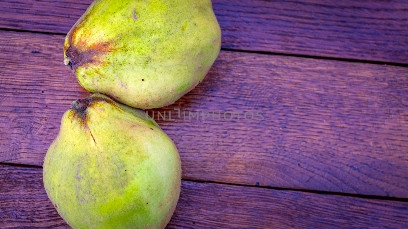 Fresh ripe yellow quince. Fruits in a wooden table