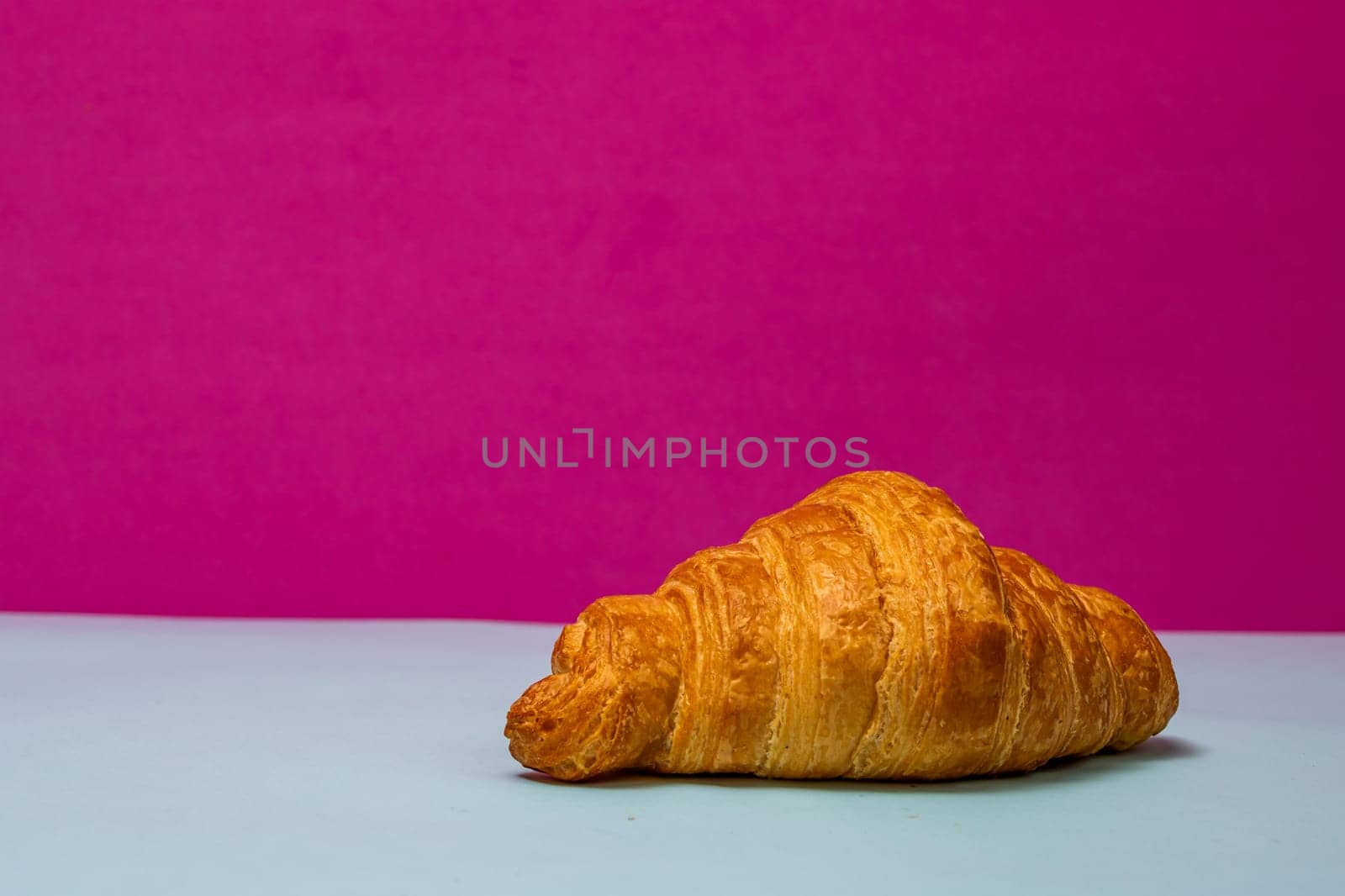 Detail of fresh croissant isolated, french breakfast concept. by vladispas