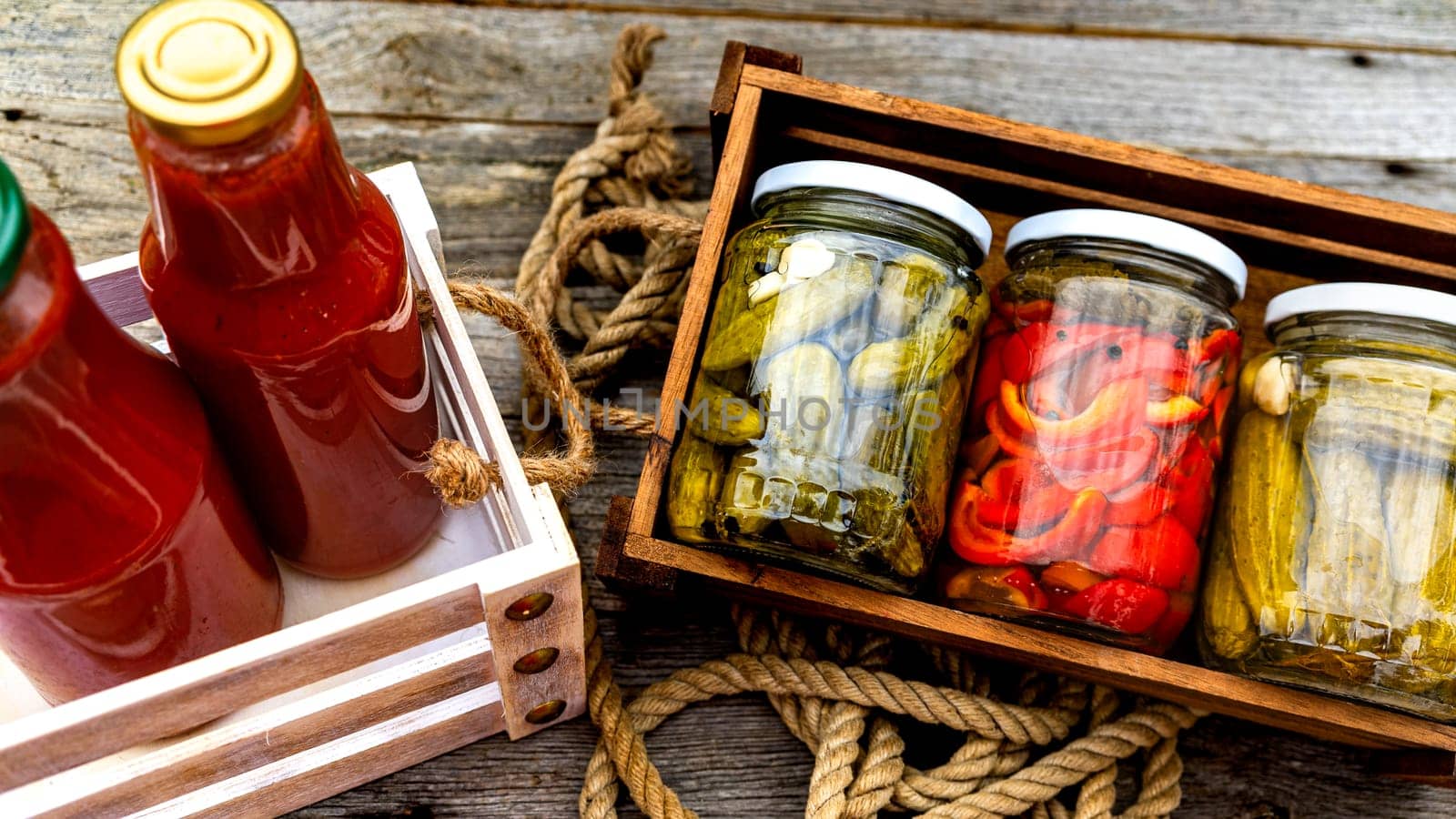 Top view of bottles of tomato sauce, preserved canned pickled food concept isolated in a rustic composition. by vladispas