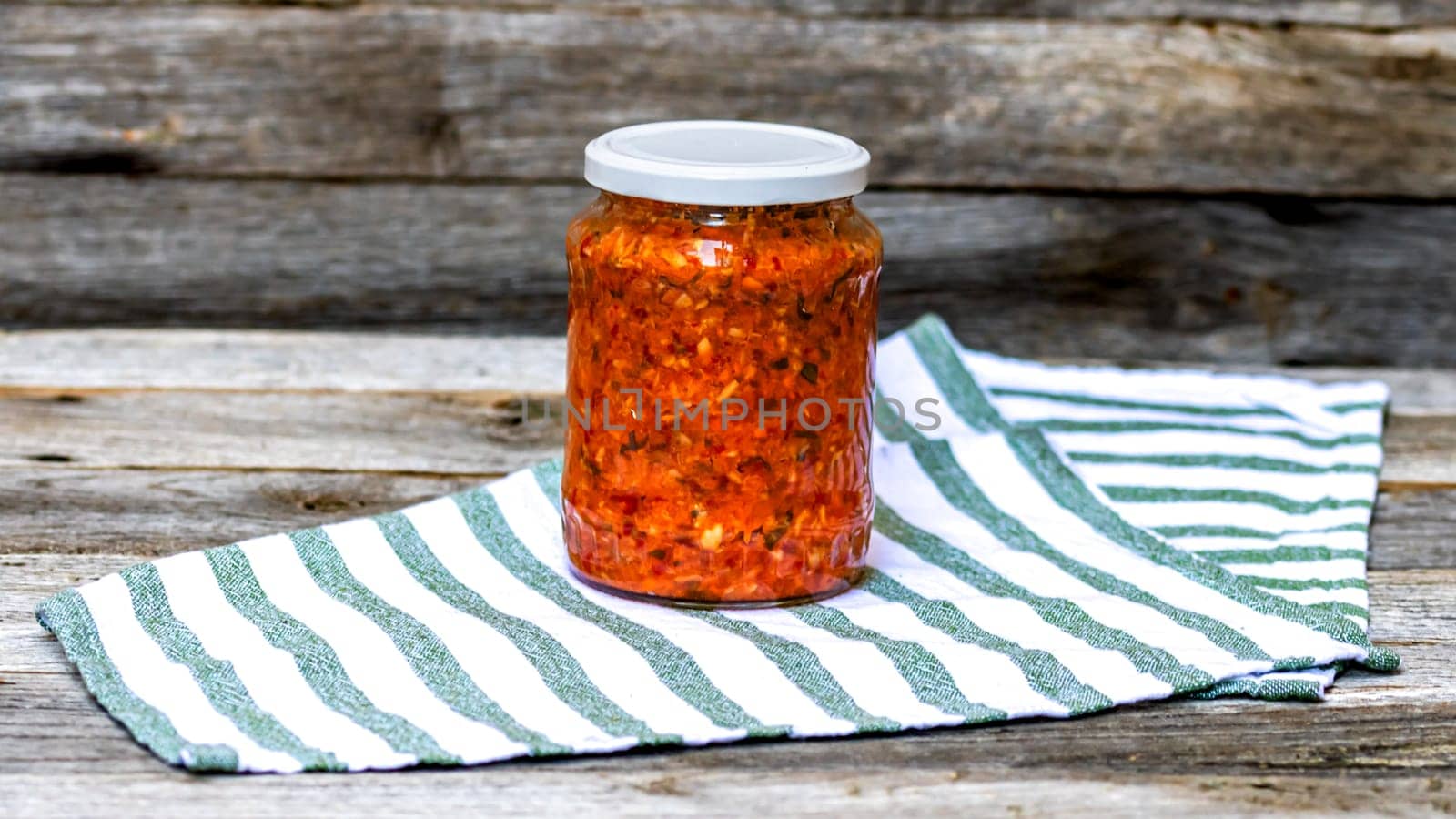 Glass jar with canned vegetables. Preserved food concept, canned vegetables isolated in a rustic composition. by vladispas