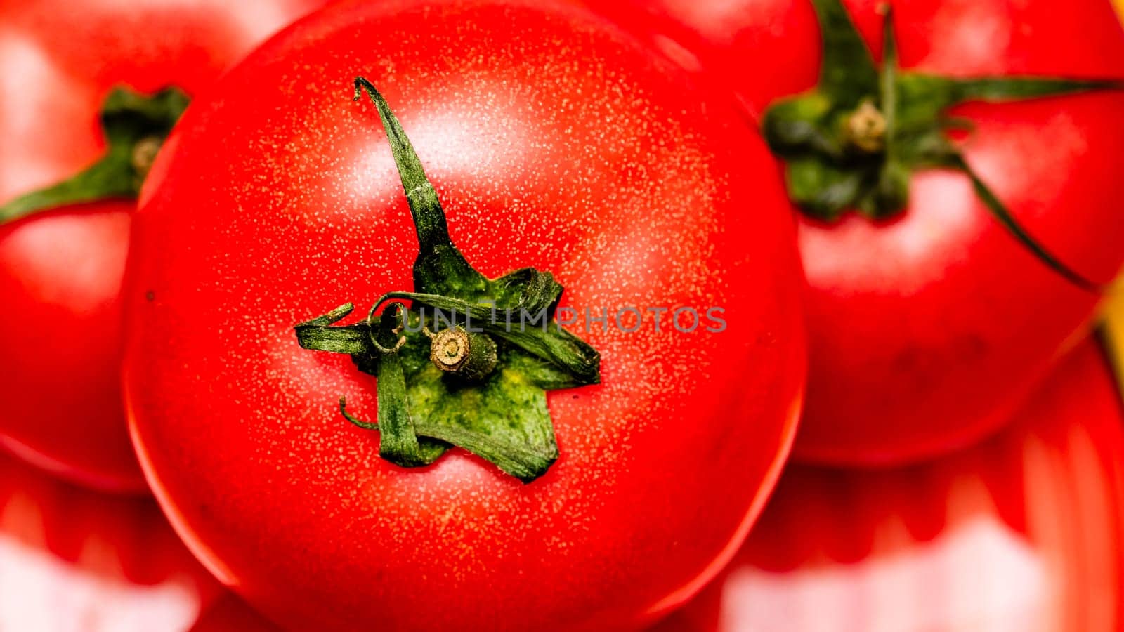 Close up of ripe red tomato, tomatoes background. by vladispas