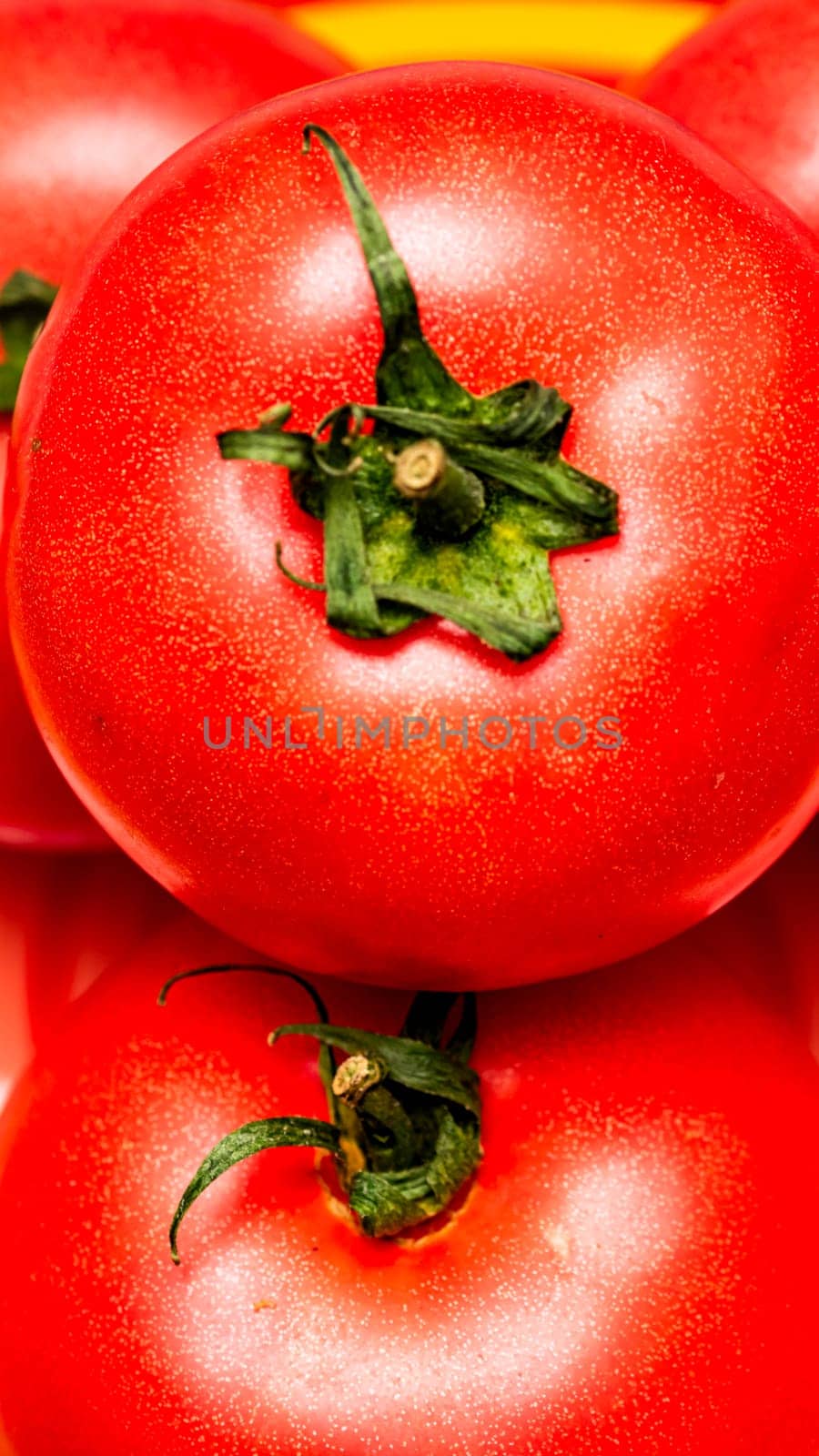 Close up of ripe red tomato, tomatoes background. by vladispas