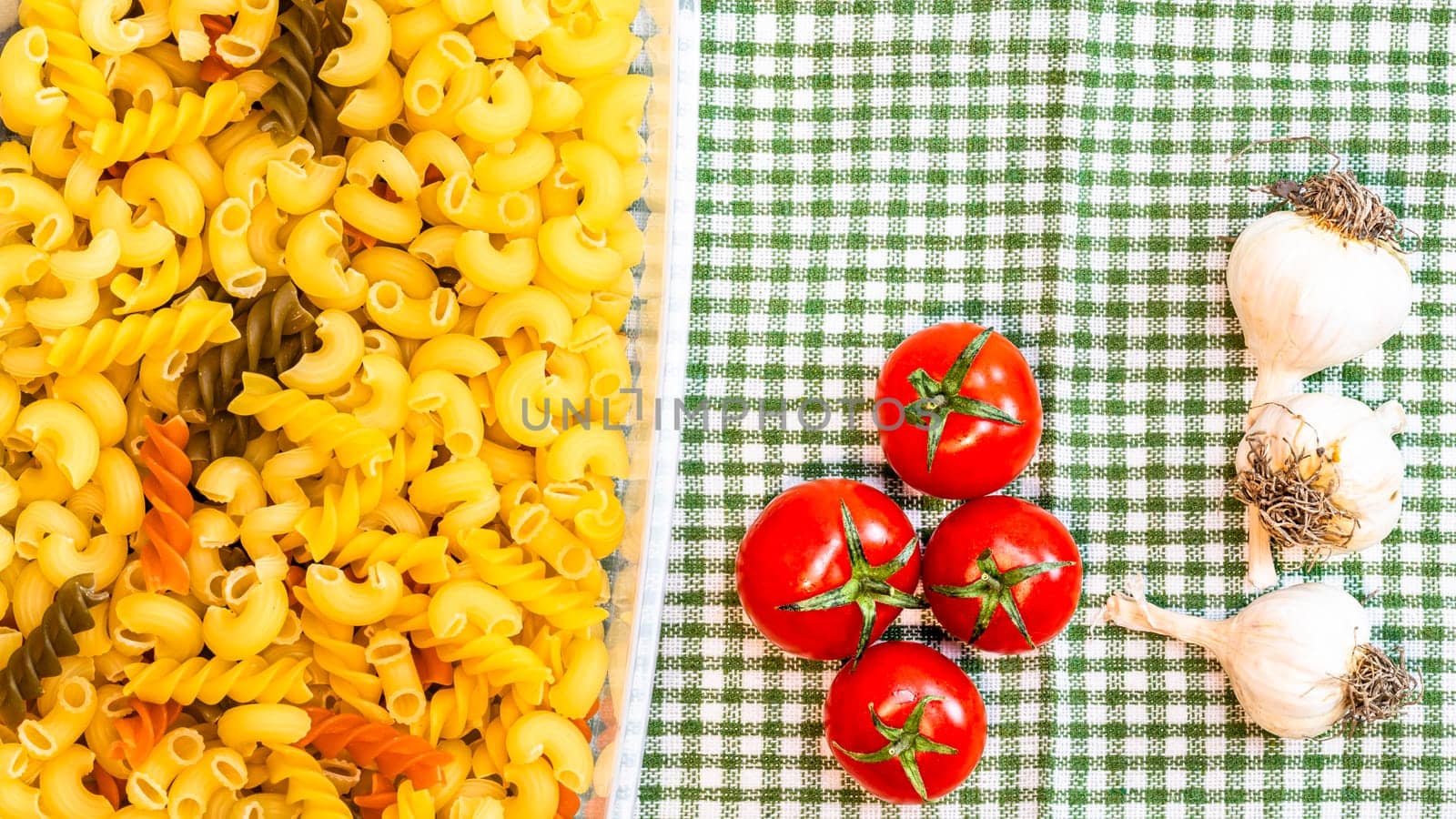 Beautiful tasty Italian pasta, tomatoes, onions and garlic for cooking pasta