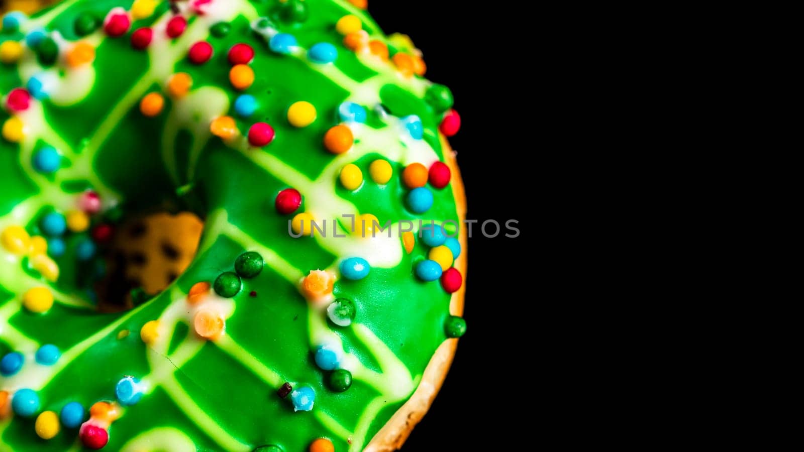 Green glazed donut with sprinkles isolated. Close up of colorful donut. by vladispas