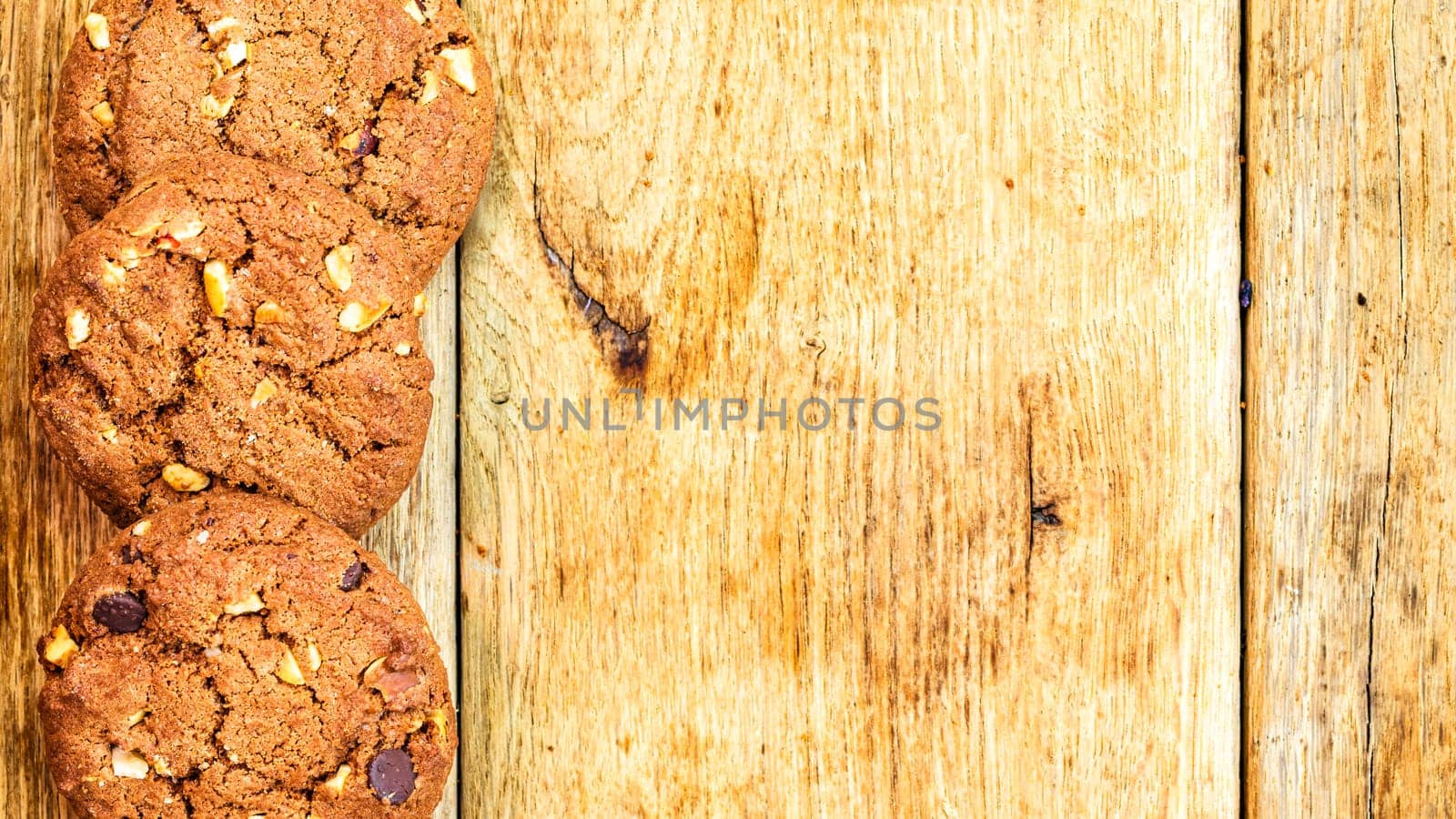 Biscuits on wooden table. Chocolate cookies on the table, breakfast concept. Top view with copy space by vladispas