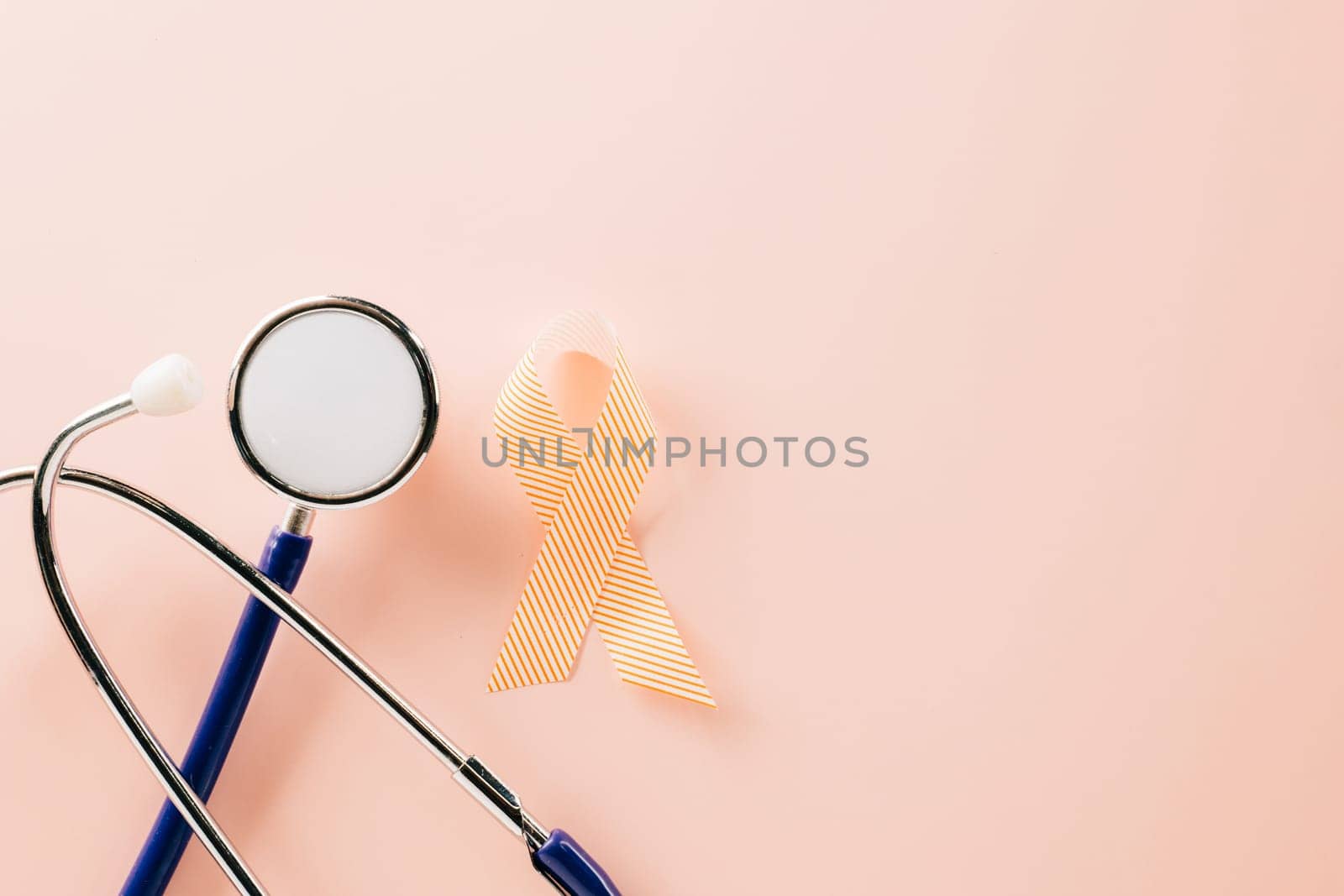 Pink awareness ribbon sign and stethoscope of International World Cancer Day campaign month on pastel pink background with copy space, concept of medical and health care support, 4 February