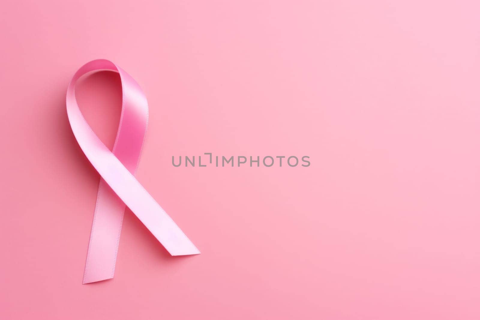 Pink cancer awareness ribbon, pink background. Generative AI.