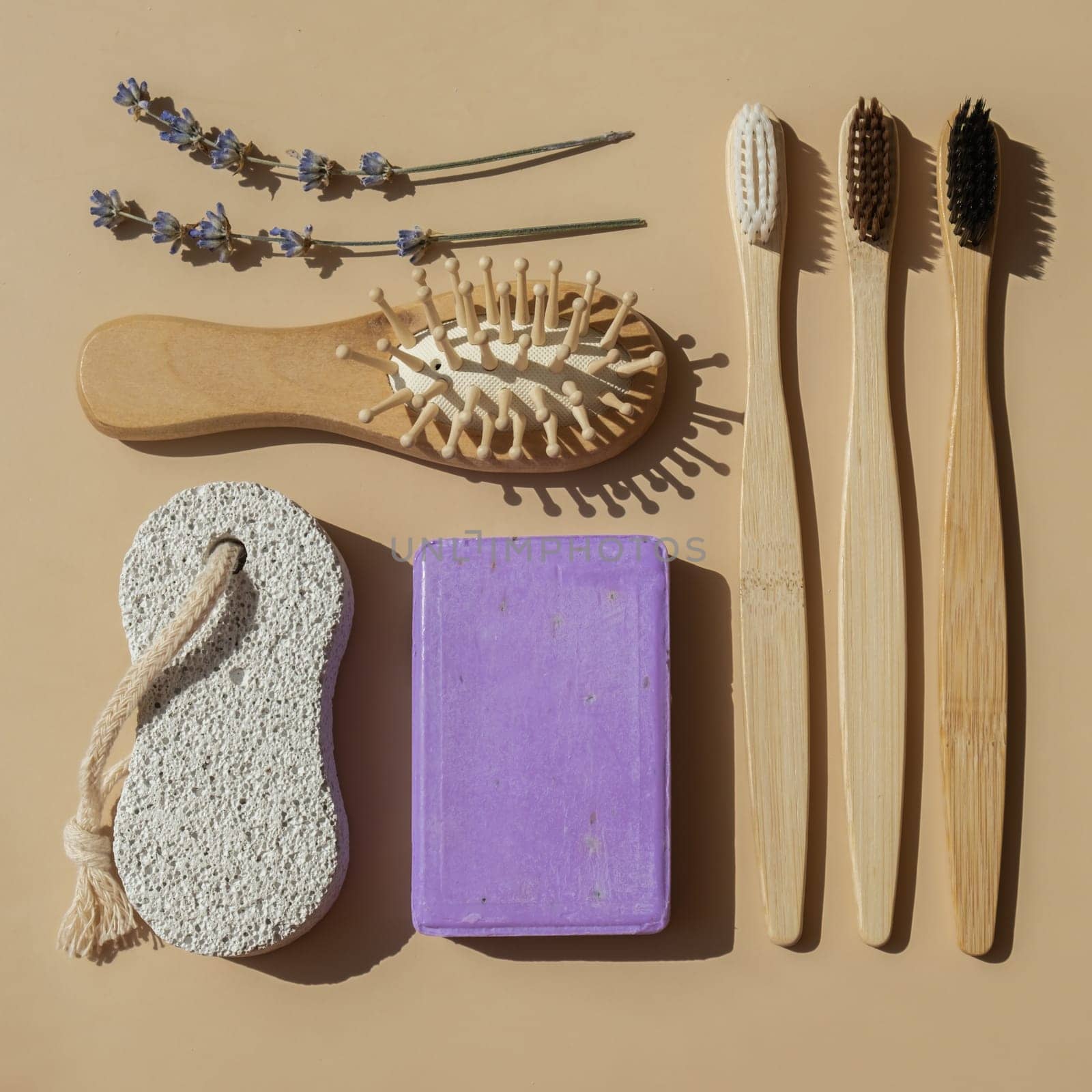 Conceptual geometric green recycling flat lay Lavender soap on beige background bamboo toothbrush, hair comb. Skincare homemade natural cosmetic concept. Organic zero waste products. Handmade soap