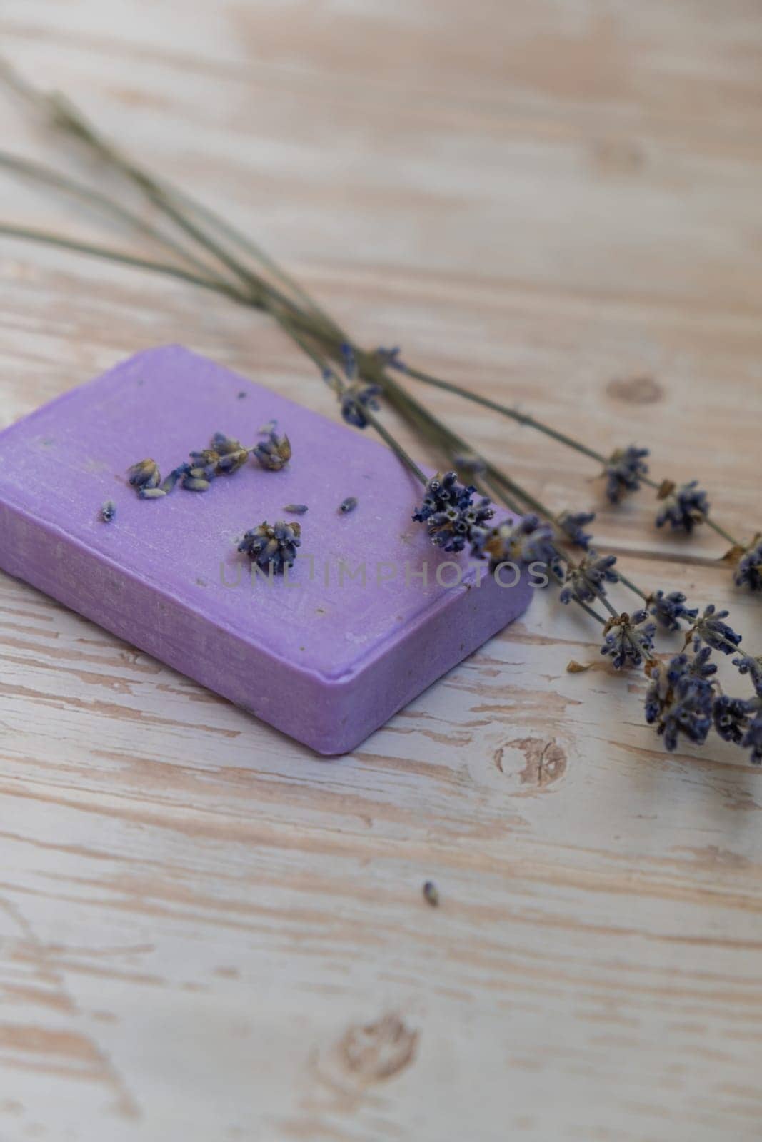 Handcrafted purple lavender soap with lavender flowers. Natural hydrating moisturiser softness cosmetic. Organic calming beauty skincare product. Herbal self care wellness alternative soap. Copy space