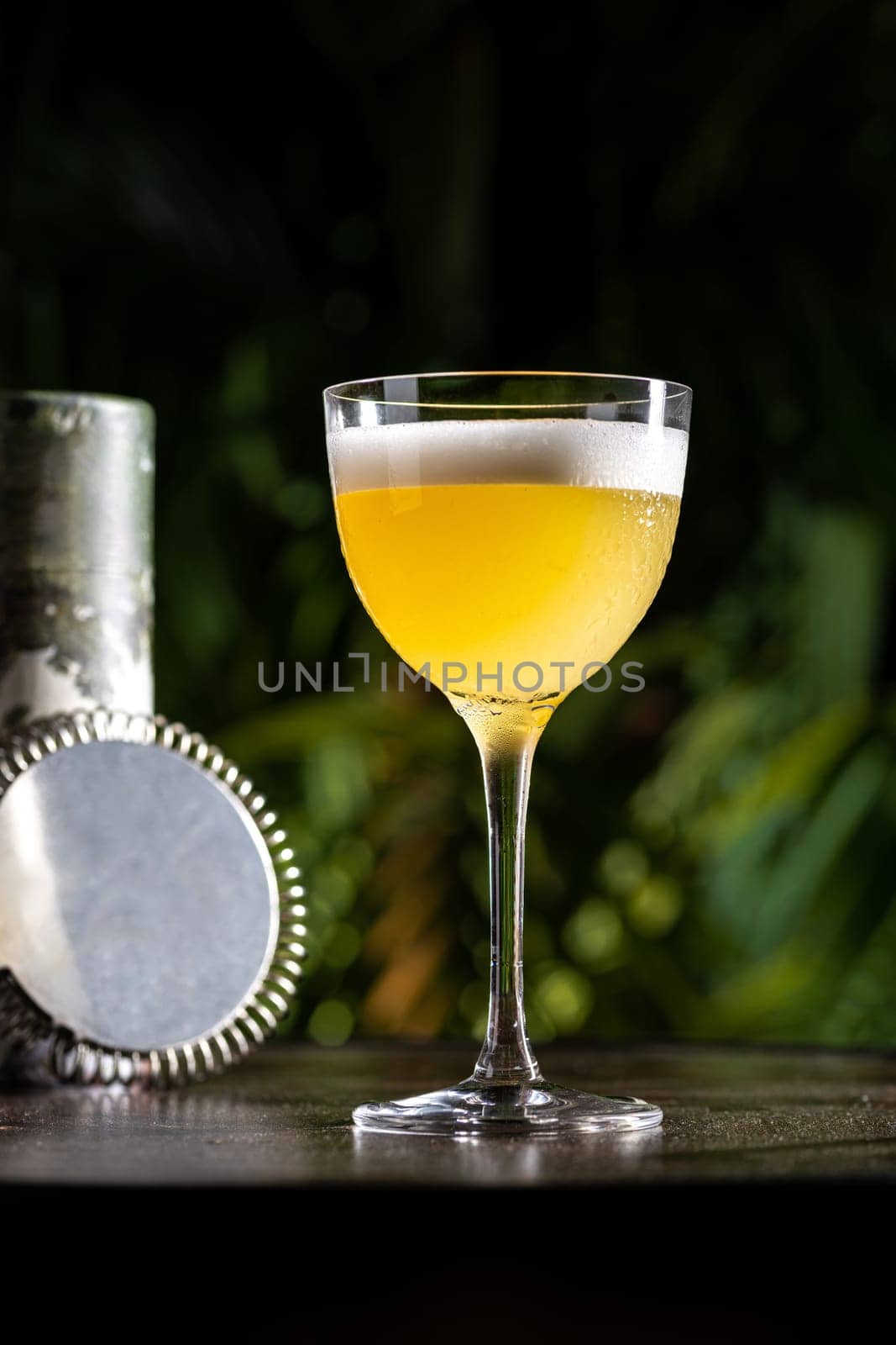 Luxury cocktail on the wooden table on a dark background by Sonat