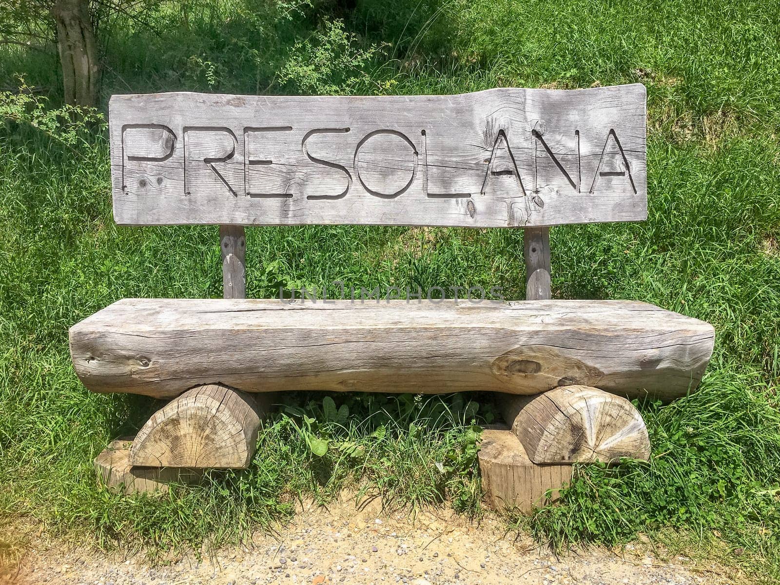 Wooden bench. The Presolana pass is an Alpine pass in the Bergamo Prealps, which connects the Seriana Valley and its branch Val Borlezza to the Scalve Valley. The area is characterized by the presence of popular tourist facilities and a ski resort. Passo della Presolana - BG, ITALY - July 17, 2023