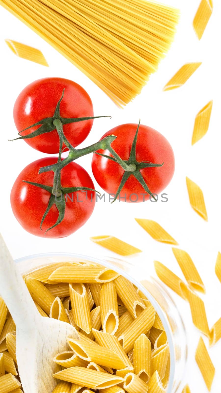 Uncooked raw italian pasta with tomatoes by germanopoli