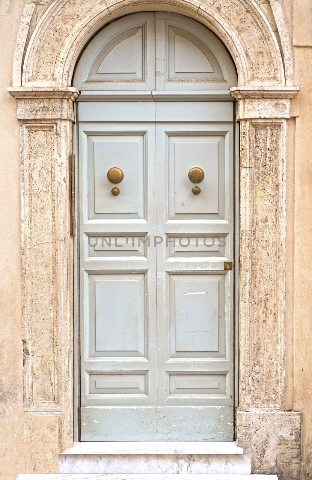 doors of Rome. Classic old wooden door in a public place on a city street or in an urban environment by aprilphoto