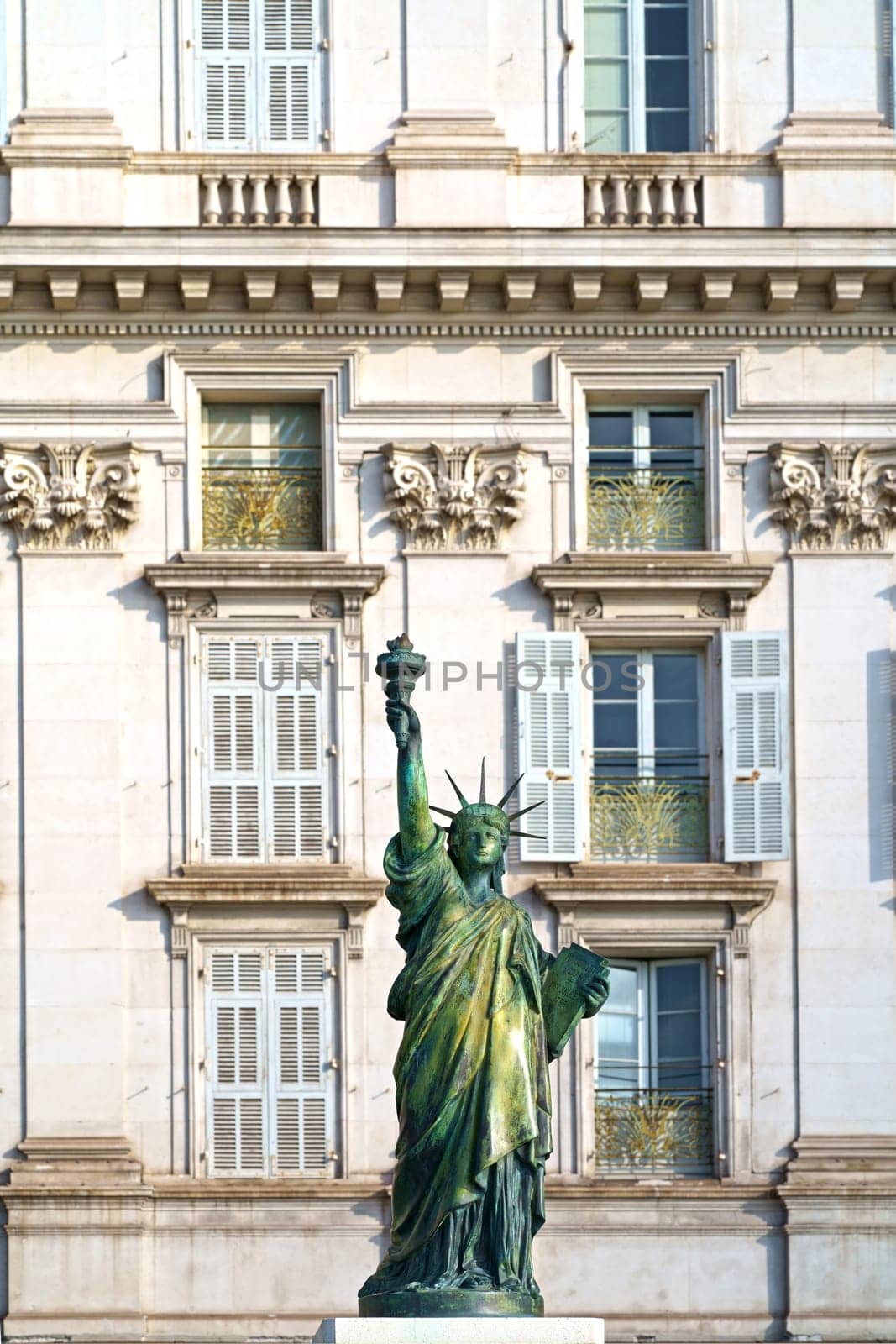 Small replica of the Statue of Liberty on Promenade des Anglais in Nice, France. Statue is made by Bartholdi and is one of several statues which helped him create the huge New York statue by aprilphoto
