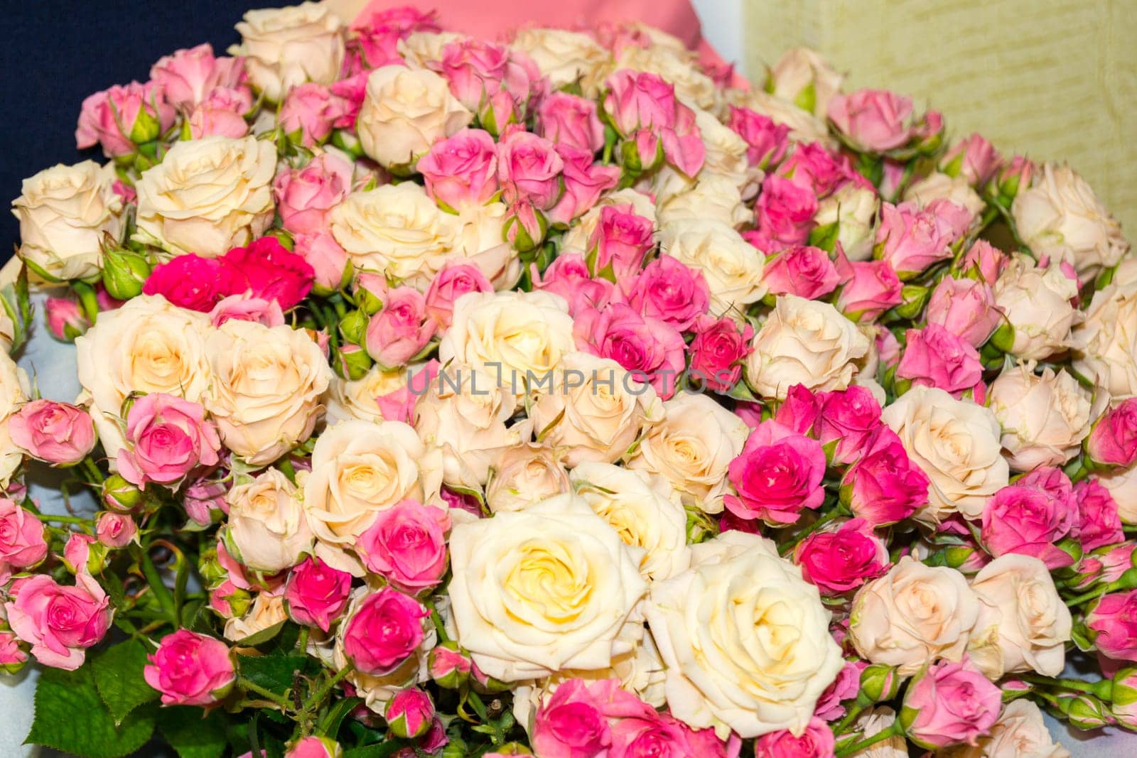 A very large bouquet of yellow and pink roses.