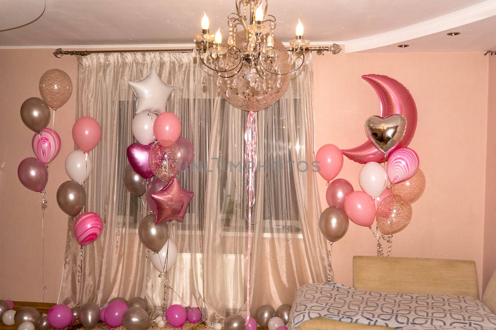 The room is decorated with various balloons.