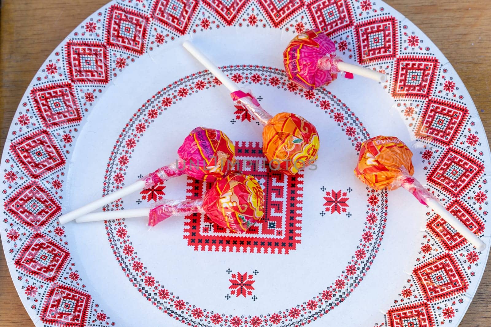 Candies on a plate with Ukrainian ornament. Ukraine, Vinnytsia, 02.06.2023 by Serhii_Voroshchuk