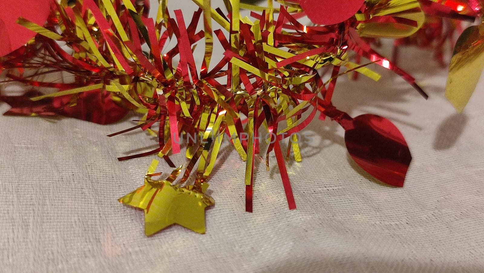 red and yellow Christmas garland, white lace tablecloth. High quality photo