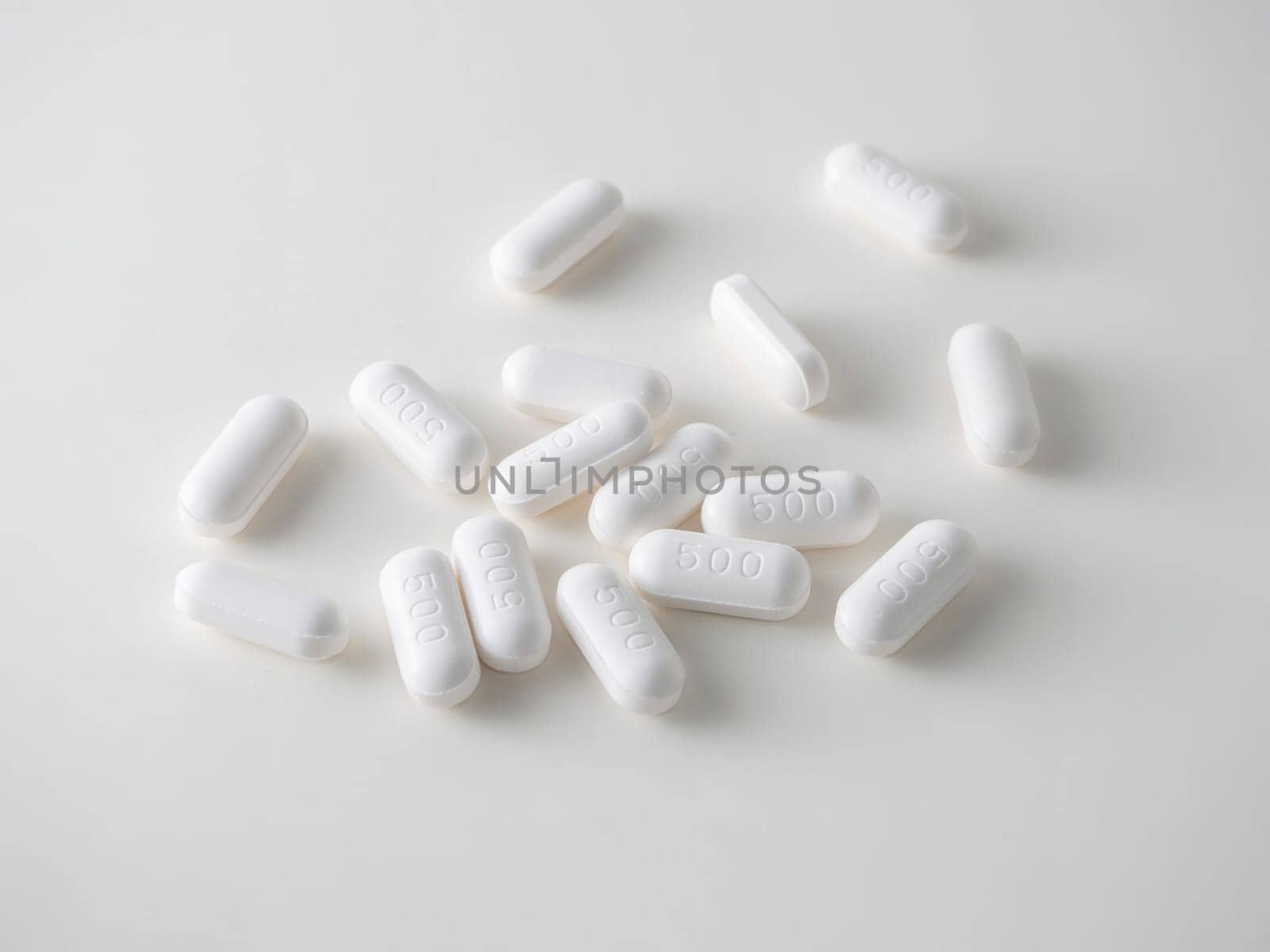 white medical tablets over white.