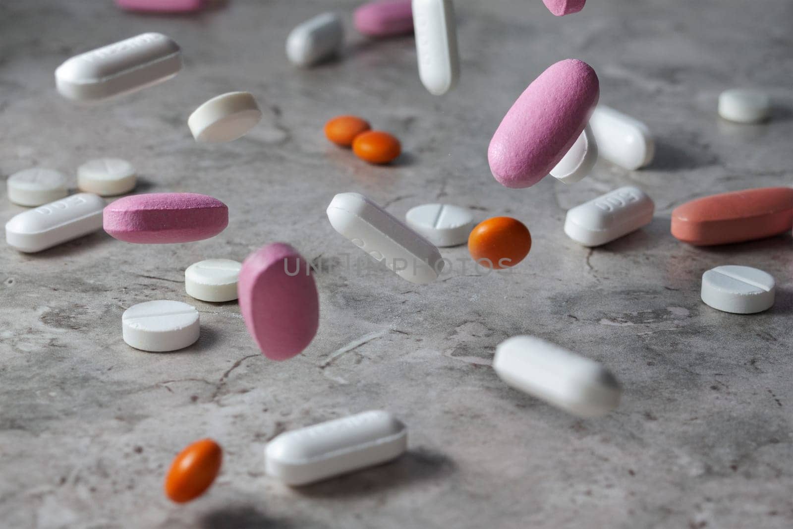 Pharmacy background on a dark table. Levitation pills. Tablets on a dark background which falling down. Pills. Medicine and healthy. Close up of capsules