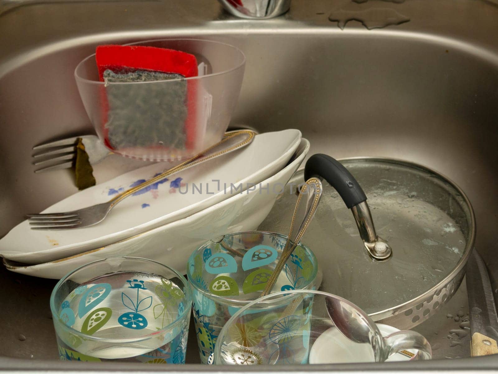Pile of dirty dishes in the sink